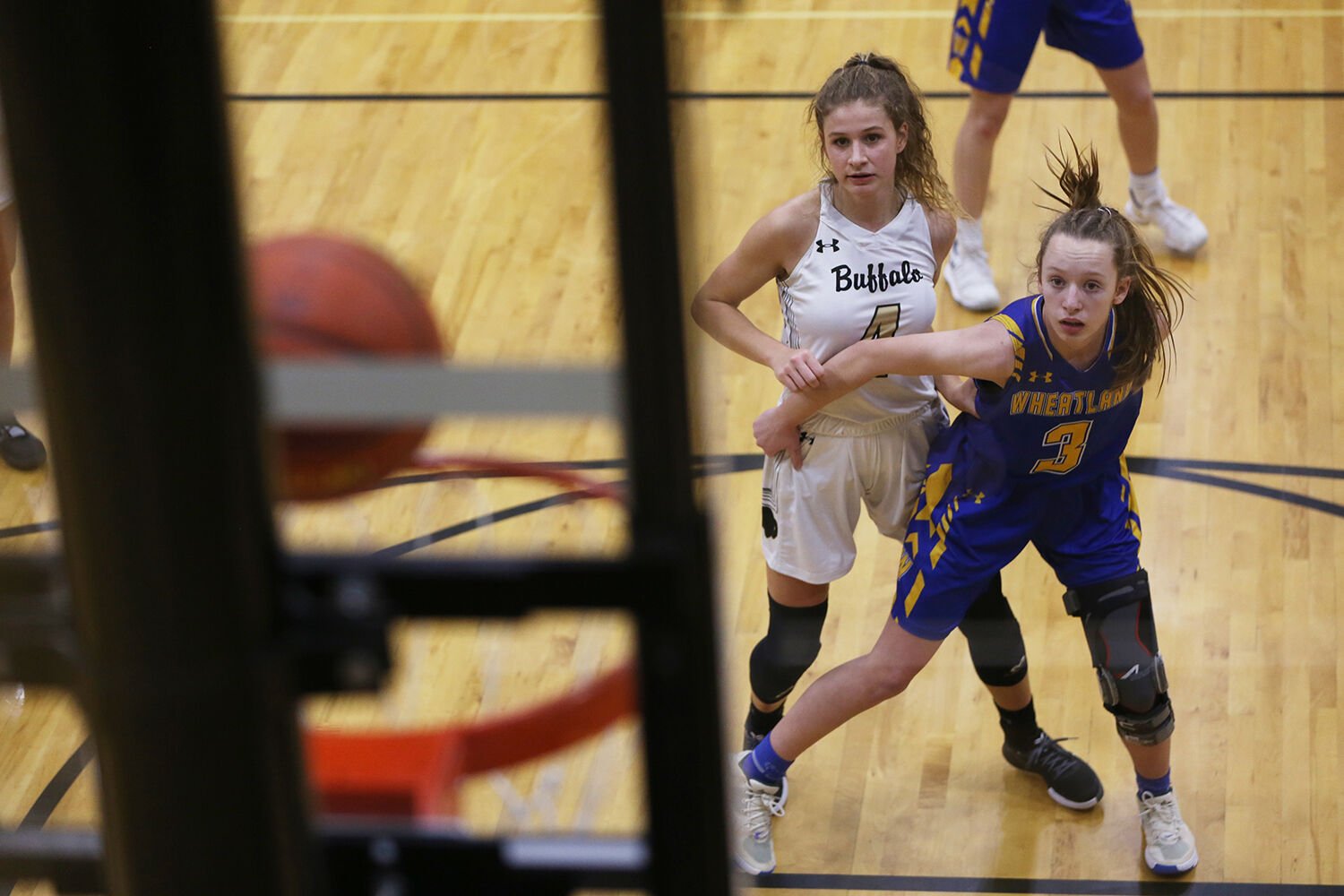 Lexi Rule and Kendall Schaffner watch the ball fall into the net